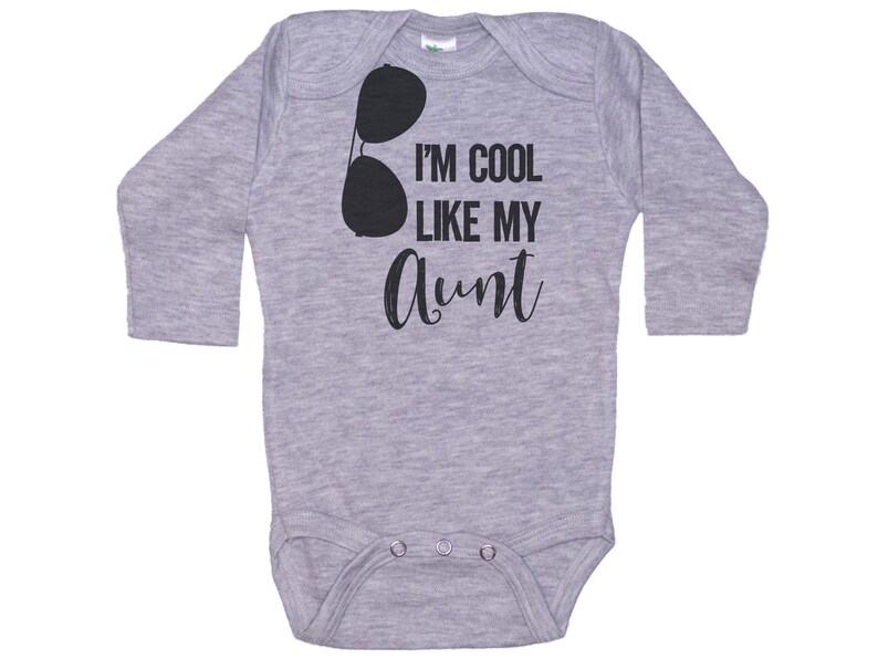 May include: Gray long-sleeve baby bodysuit with black text that reads "I'm cool like my aunt" and a pair of sunglasses graphic.