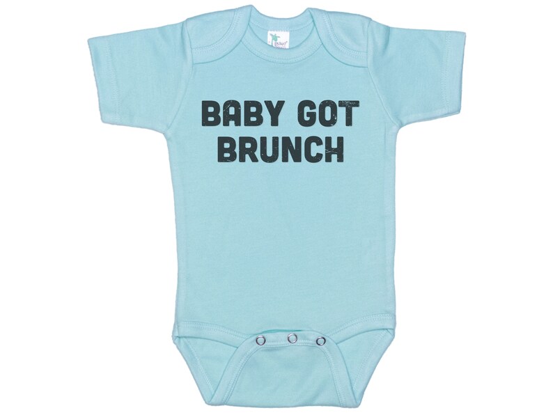 May include: A light blue baby onesie with short sleeves and a black print that says "BABY GOT BRUNCH".