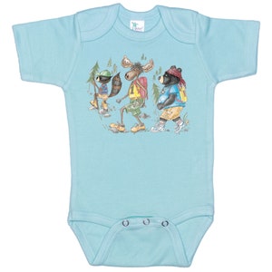 May include: A light blue baby onesie with a graphic print of a raccoon, moose, and bear wearing backpacks and hiking in the woods.