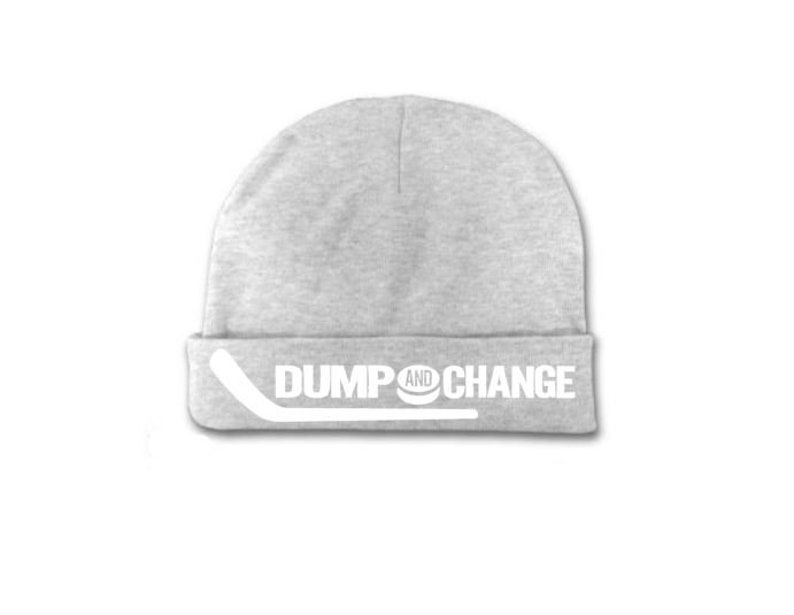 May include: Gray beanie with a white hockey stick and puck graphic and the text "DUMP AND CHANGE".