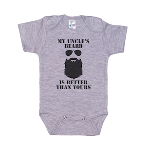 May include: Gray baby onesie with a black graphic of a bearded man wearing sunglasses and the text "My Uncle's Beard Is Better Than Yours".