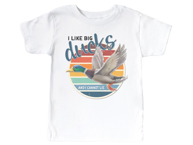 May include: White t-shirt with a retro sunset graphic and a flying duck. The text reads "I like big ducks and I cannot lie."