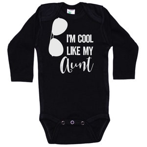 May include: Black long-sleeve baby bodysuit with white text that reads "I'm cool like my aunt" and a pair of sunglasses graphic.
