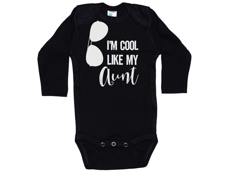 May include: Black long-sleeve baby bodysuit with white text that reads "I'm cool like my aunt" and a pair of sunglasses graphic.