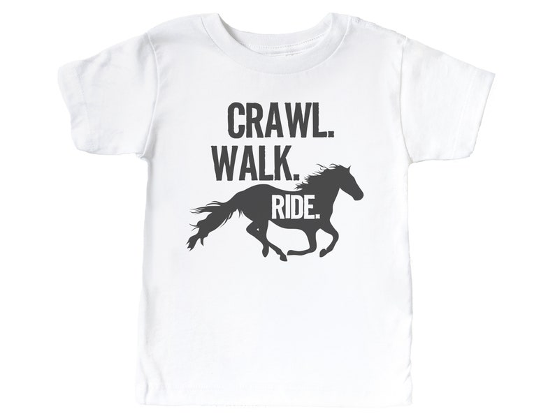 May include: White t-shirt with a black silhouette of a horse running and the text "Crawl. Walk. Ride."