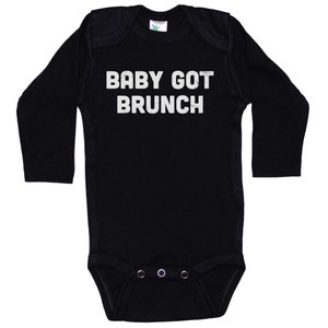 May include: Black long-sleeve baby onesie with white text that reads "BABY GOT BRUNCH".