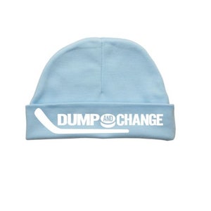 May include: A light blue baby beanie with the text "DUMP AND CHANGE" in white, with a white hockey stick graphic.