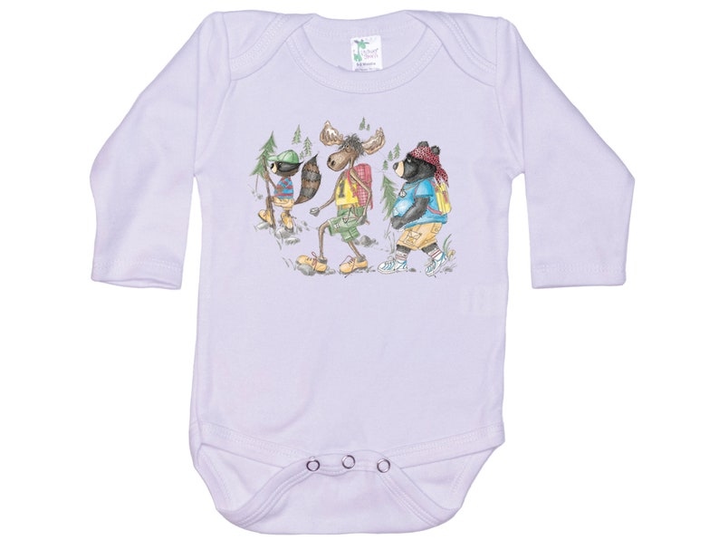 May include: A white long-sleeved baby onesie with a graphic of a moose, a raccoon, and a bear wearing backpacks and hiking in the woods.