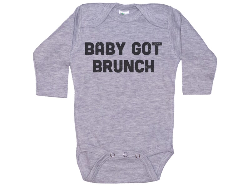 May include: A gray long-sleeve baby onesie with black text that reads "BABY GOT BRUNCH".