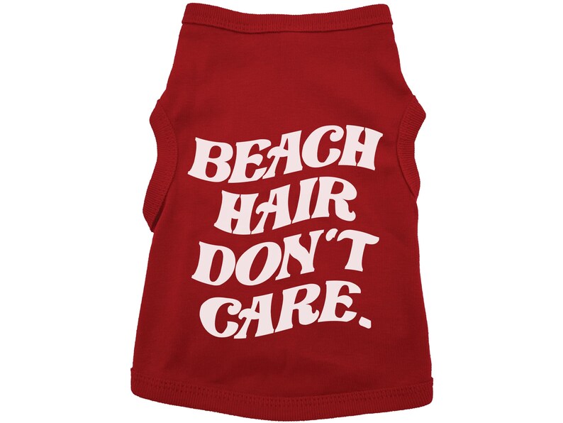 May include: Red sleeveless dog shirt with white text that reads "Beach Hair Don't Care."