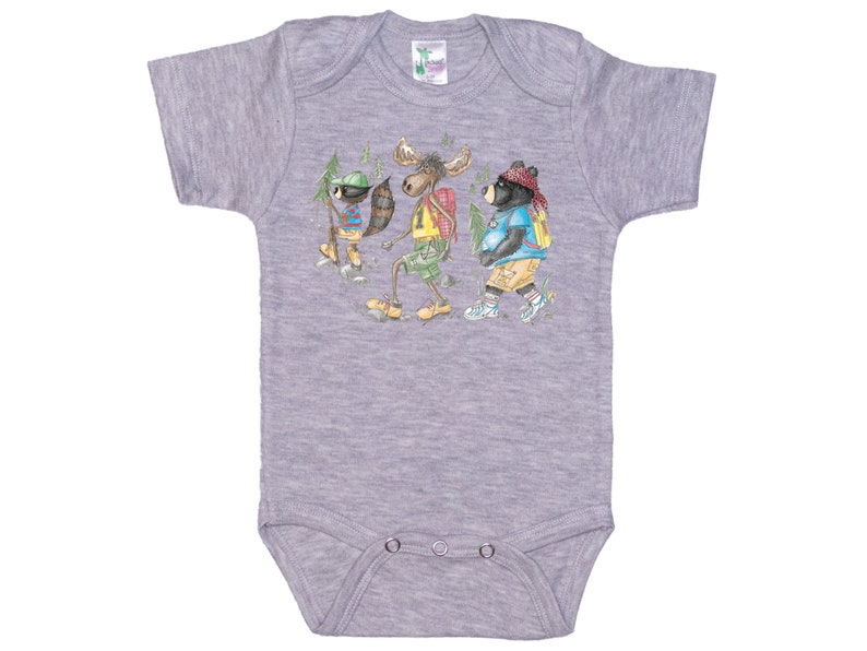 May include: A grey short-sleeved baby onesie with a graphic of a raccoon, moose, and bear wearing backpacks and hiking in the woods.