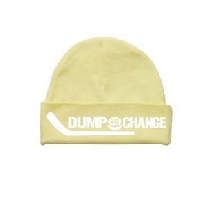 May include: A yellow beanie with the words "DUMP AND CHANGE" and a hockey stick graphic in white.
