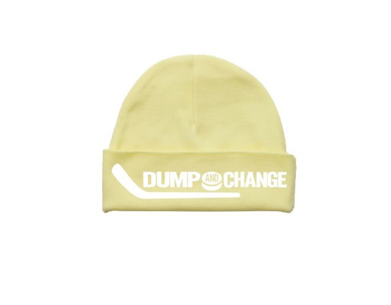 May include: A yellow beanie with the words "DUMP AND CHANGE" and a hockey stick graphic in white.