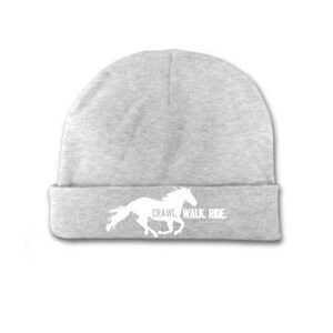 May include: Gray beanie with a white silhouette of a horse running and the text "Crawl Walk Ride" on the front.