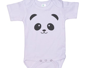 May include: A white baby onesie with a black panda face graphic. The panda has black ears, eyes, and a nose.