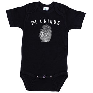 May include: Black short-sleeved bodysuit with white text that reads "I'M UNIQUE" and a fingerprint graphic.