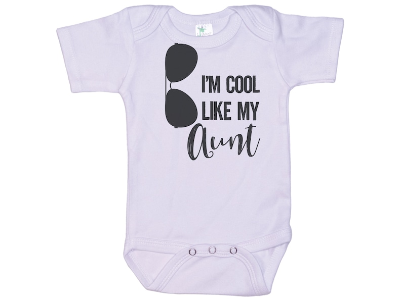 May include: A white baby onesie with short sleeves and a black graphic of sunglasses and the text "I'm cool like my aunt".