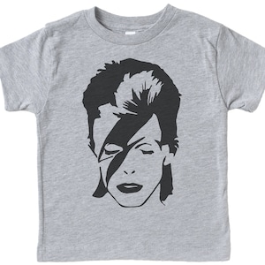 May include: A gray t-shirt with a black and white silhouette of David Bowie's face.
