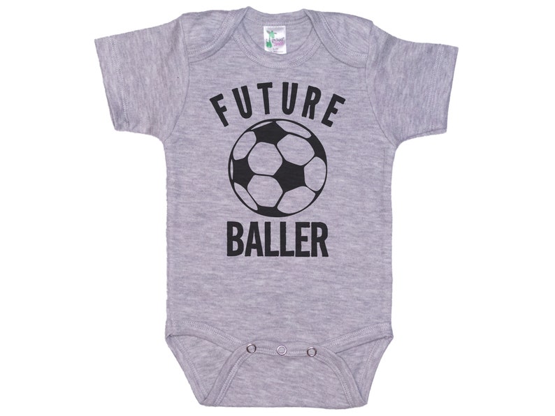 May include: Gray baby onesie with black text that reads "FUTURE BALLER" and a black and white soccer ball graphic.
