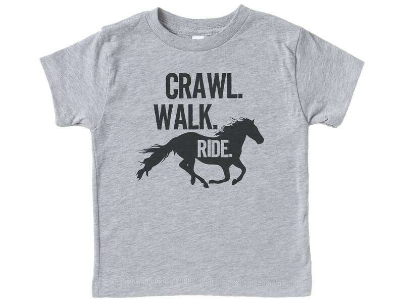 May include: Gray short-sleeved t-shirt with a black silhouette of a horse running and the text "Crawl. Walk. Ride."