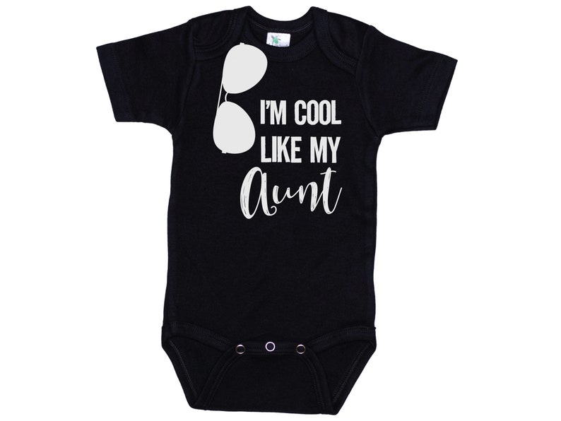 May include: Black baby onesie with white text that reads "I'm cool like my aunt" and a pair of sunglasses graphic.