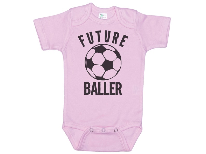 May include: Pink baby onesie with a black soccer ball and the text "FUTURE BALLER".