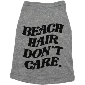 May include: Grey dog shirt with black text that reads "Beach Hair Don't Care."