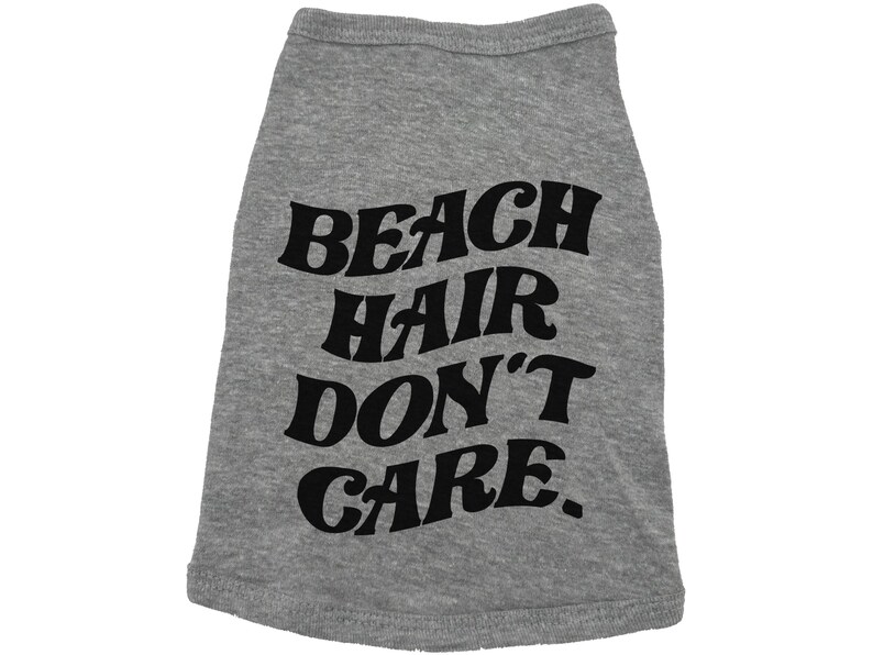 May include: Grey dog shirt with black text that reads "Beach Hair Don't Care."