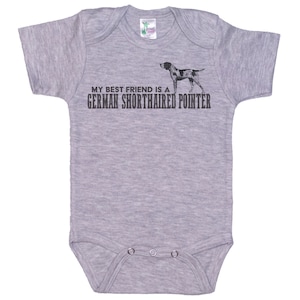 May include: Gray baby onesie with a black and white illustration of a German Shorthaired Pointer dog and the text "My best friend is a German Shorthaired Pointer."