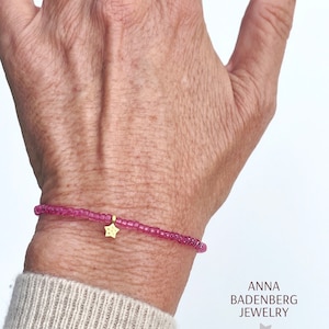 BRACELET made of Preciosa Rocailles / glass beads in raspberry clear. Spacer and star charm made of 925 sterling silver, 24Kt gold plated