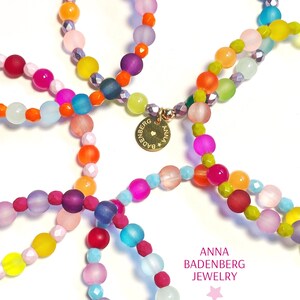 BRACELET made of glass beads, frosted, smooth and Bohemian cut glass beads, spacer made of sterling silver, 24Kt gold plated with logo pendant