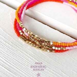 BRACELET made of glass beads (2 mm) in pink and orange, hematite beads 24K gold plated, faceted, charm logo, sterling silver, gold plated
