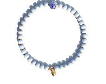 BRACELET made of light blue glass beads (rocailles) opaque and a millefiori bead, spacer 925 sterling silver 24K gold-plated heart charm