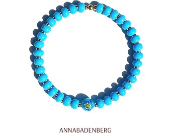 BRACELET made of glass beads (rocailles) in blue opaque and a millefiori bead, spacer 925 sterling silver 24K gold plated