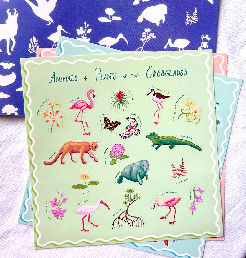 May include: A set of Everglades-themed stickers with illustrations of animals and plants, including a flamingo, alligator, butterfly, and manatee. The text "Animals & Plants of the Everglades" is displayed. The stickers are on a light green background.