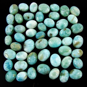 May include: A collection of 35 oval-shaped blue and green gemstone cabochons. The stones have a cloudy, marbled appearance.