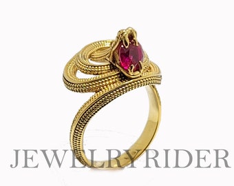 Snake biting a ruby ring