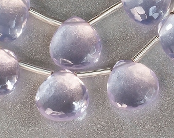 May include: A strand of pale lavender faceted gemstone beads in a heart shape. The beads are strung on a silver wire.