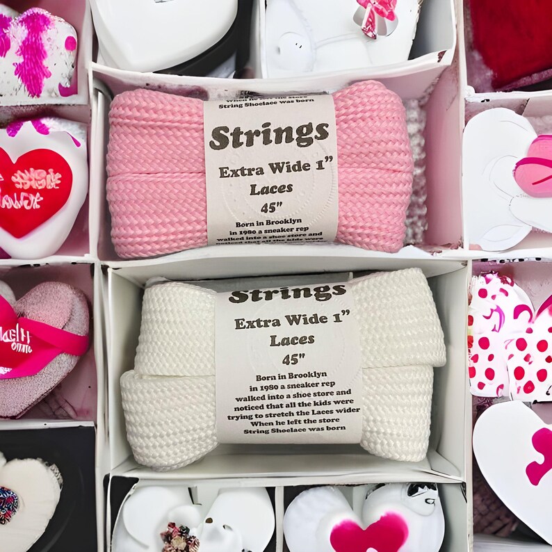 May include: Two pairs of extra wide shoelaces in pink and white. The shoelaces are 45 inches long and are packaged in a white box with a black label that says "Strings Extra Wide 1" Laces 45"  Born in Brooklyn in 1980 a sneaker rep walked into a shoe store and noticed that all the kids were trying to stretch the Laces wider When he left the store String Shoelace was born"