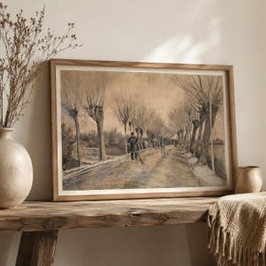 May include: A framed landscape print depicting a dirt road lined with tall, bare trees and two figures walking along the path. The artwork features a muted, sepia-toned color palette with dark brown and grey ink lines, presented in a light wood frame.