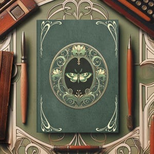 May include: A green journal with an ornate gold and green design featuring a butterfly. The journal has a decorative border and a circular design with a butterfly in the centre.