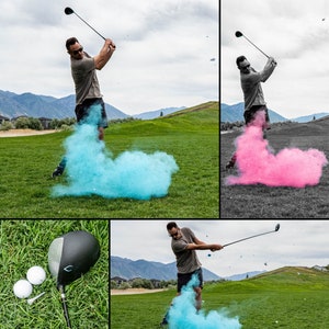 May include: A golfer swings a golf club, creating a blue cloud of coloured powder. The golfer is wearing a green shirt and khaki shorts. The golf course is green and grassy. There is a golf ball on the ground.
