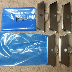May include: A set of six silver metal bag holders with a blue plastic bag and a silver metal connector.