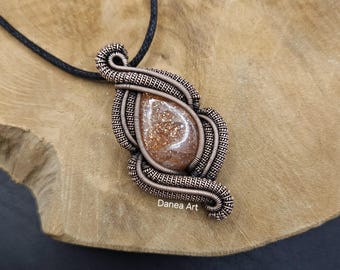 Wire Wrapped Sunstone Pendant In Oxidised Copper.