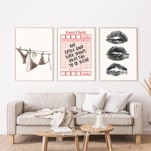 May include: Three framed art prints. The left print shows a leopard print bikini hanging on a clothesline. The centre print is a red and white "Guest Check" with text. The right print displays three black lipstick kiss marks.
