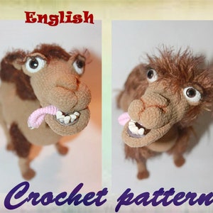 May include: Crocheted camel amigurumi toy with large eyes and a pink tongue sticking out. The camel is brown and has a furry texture.