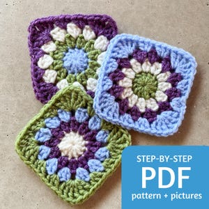 May include: Three colorful crocheted granny squares in shades of purple, green, and blue. Each square features a floral design with a white center. A blue rectangle with white text that reads "STEP-BY-STEP PDF pattern + pictures" is in the lower right corner.