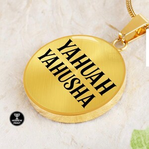 May include: Gold pendant necklace with a round disc featuring the words "Yahua Yahusha" in black lettering.