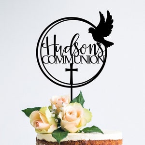 May include: Black cake topper with a circle, a dove, a cross, and the text "Hudson's Communion".