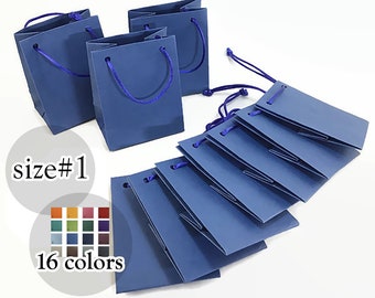 May include: Navy blue gift bags with matching rope handles and tags. The image shows several bags and tags, with a color palette of 16 colors. The text in the image says "size #1".